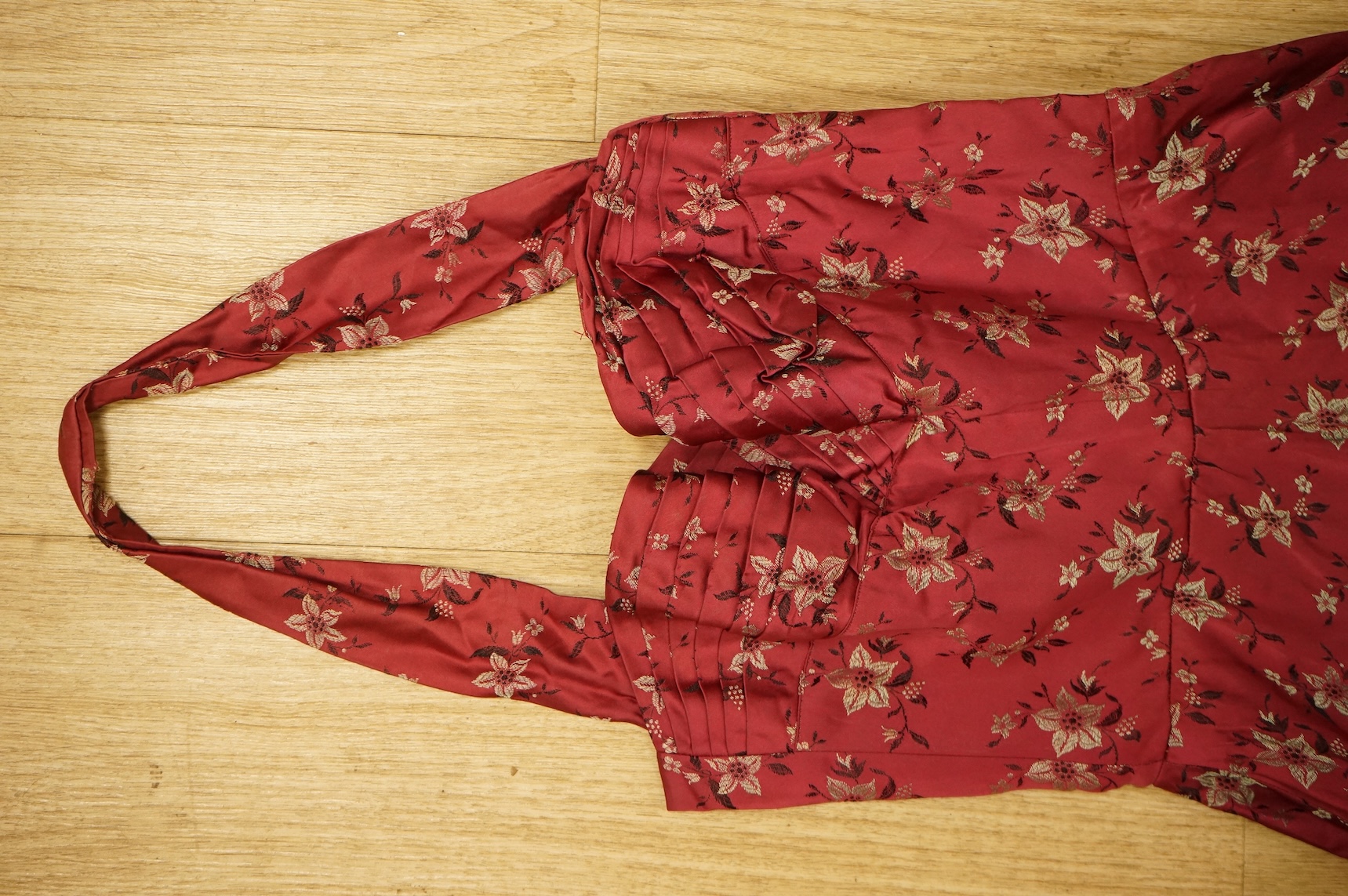 A late 1940’s black lace evening dress, a similar evening dress with black velvet ribbon detail, a maroon brocade halter neck evening dress and a dark mustard early 1950’s evening silk duster coat.